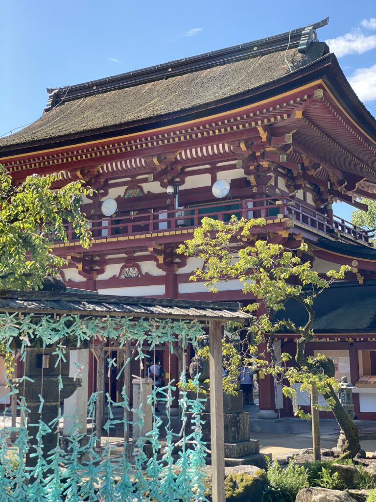 The vermilion Romon gate at Dazaifu Tenmangu seen from the courtyard below